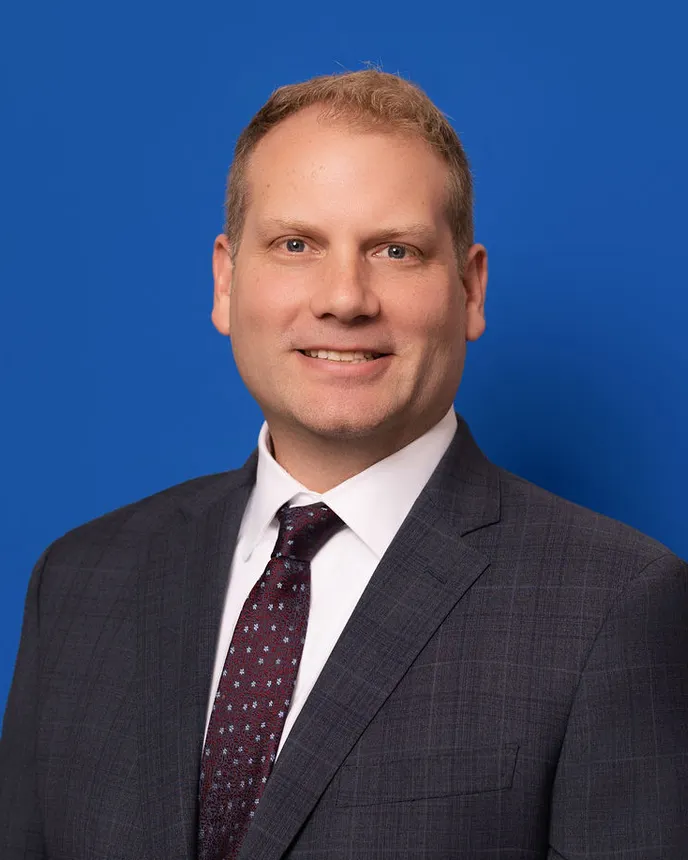 Headshot of a man in professional attire.