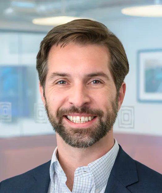 Headshot of a man in a suit.