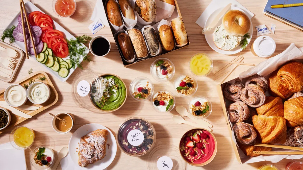 A photo of a variety of food on a wooden table on trays and in baskets and bowls.