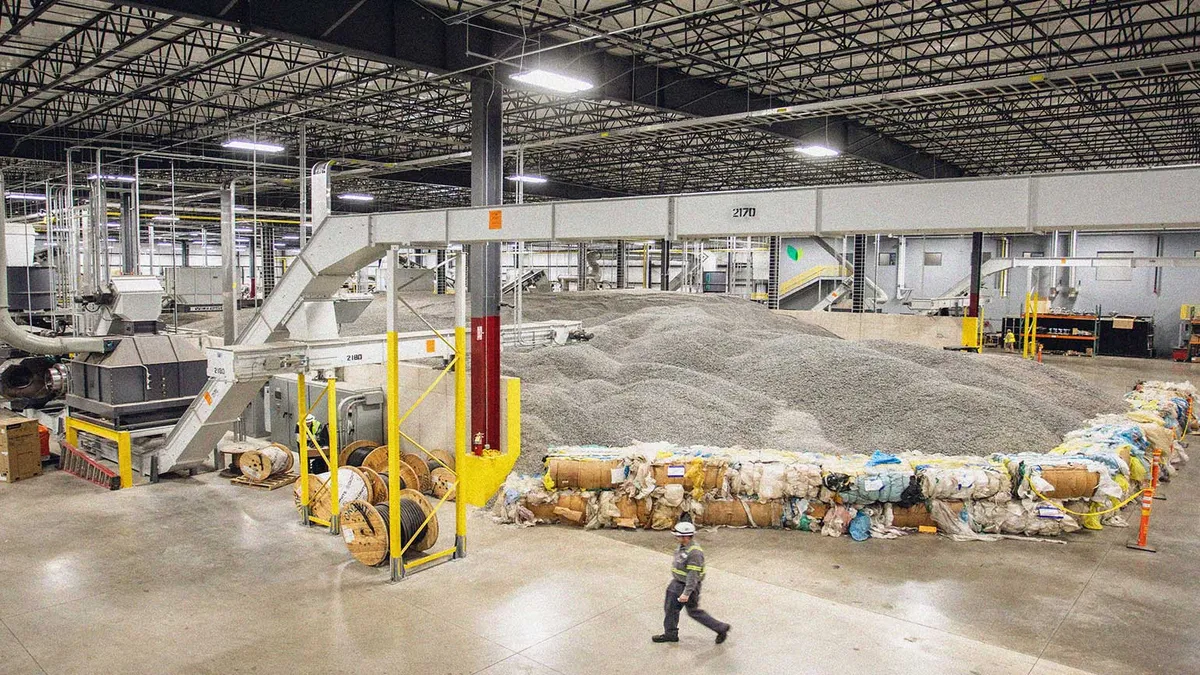 A worker walks through an industrial facility