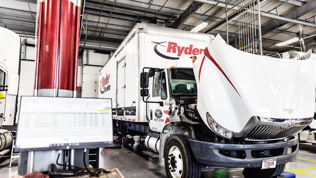 A truck's hood opened for maintenance.