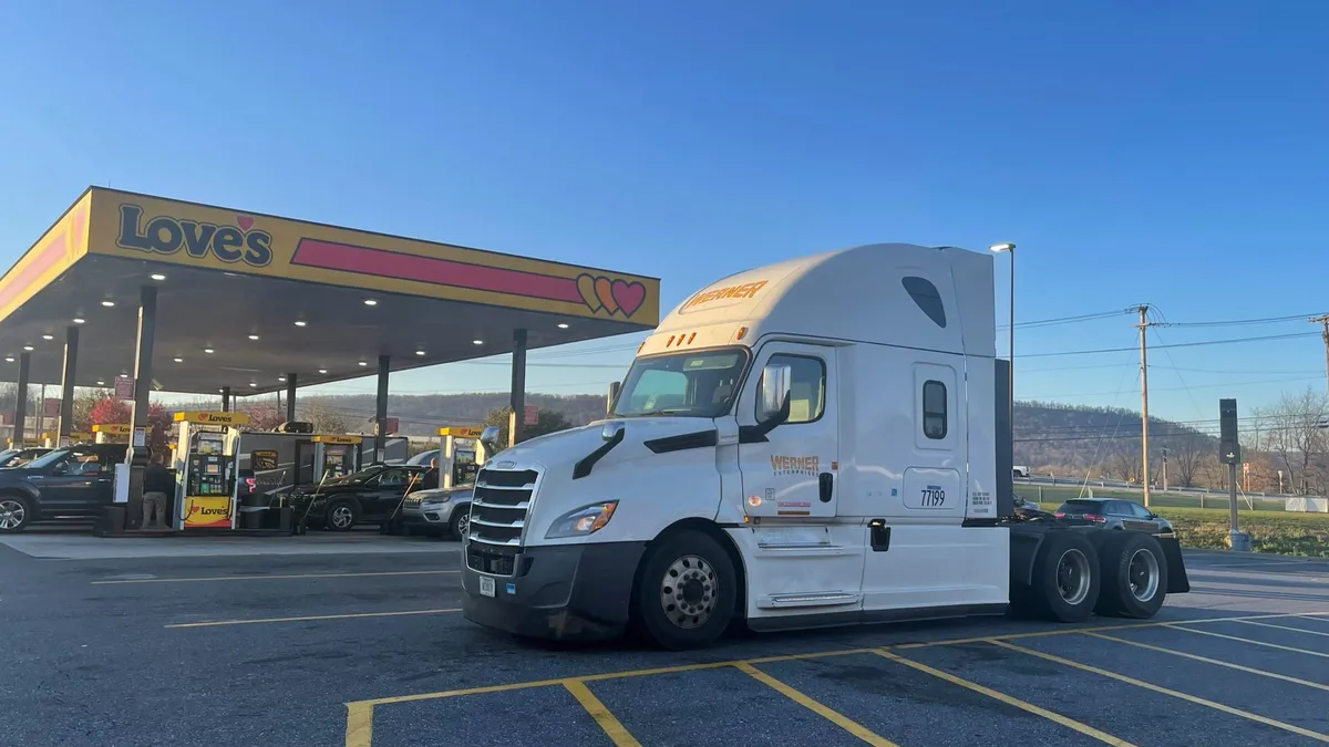 A Werner tractor parked at a Love's rest stop.