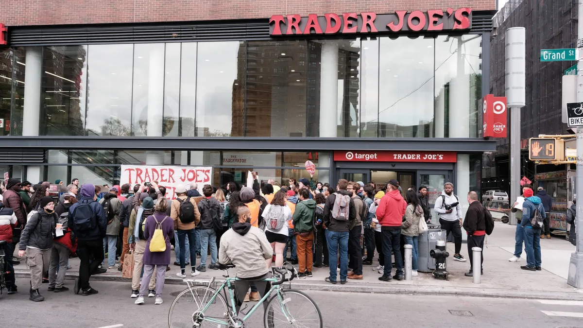 People at a rally outside a grocery store