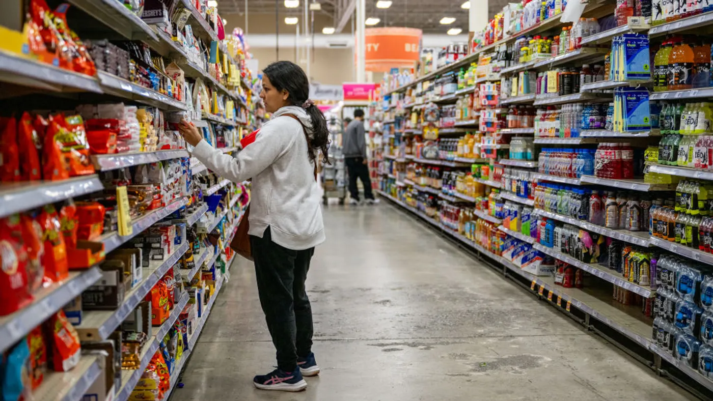 A person shops in a grocery store aisle