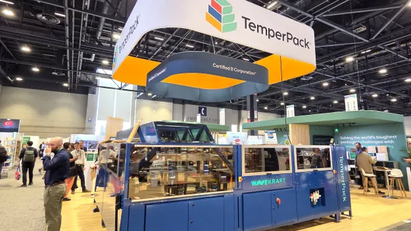 A trade show booth with manufacturing equipment and branding for TemperPack.