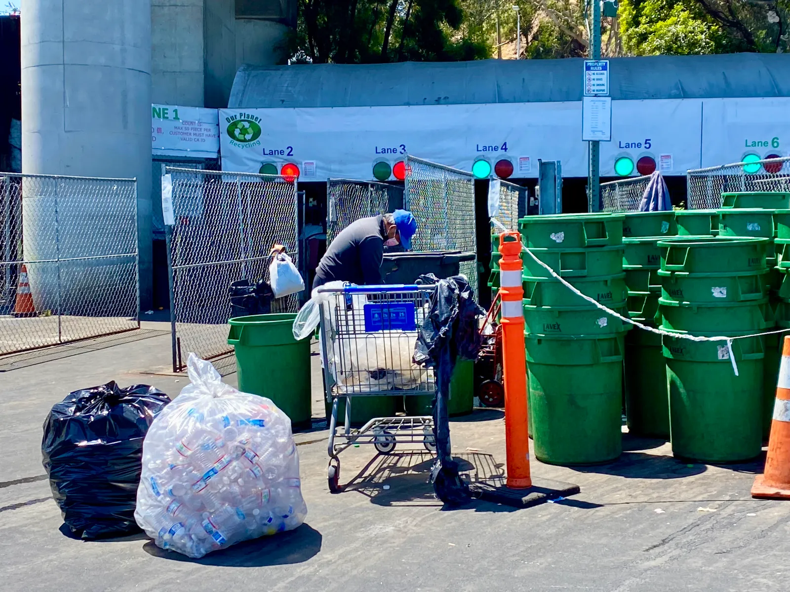 A person drops off beverage containers at a recycling center.