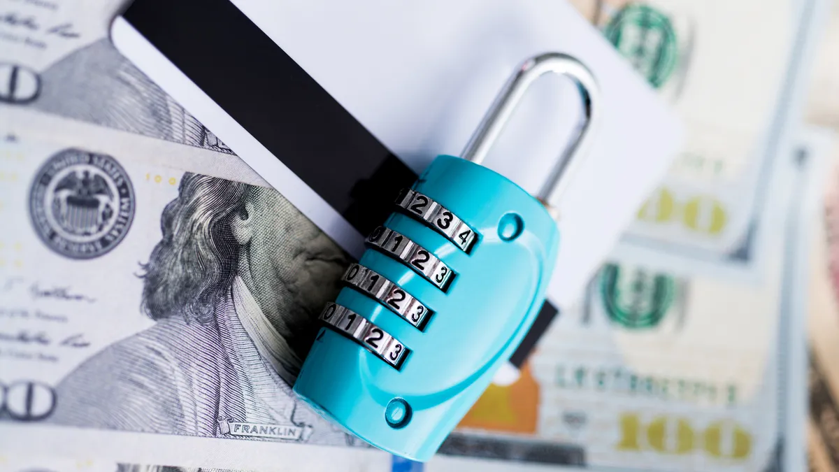 Padlock on credit cards and us dollars.