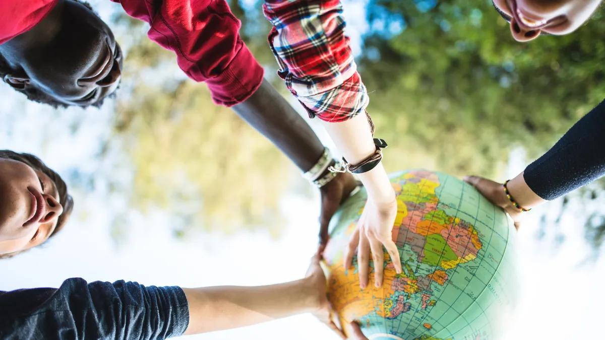 Kids holding a globe