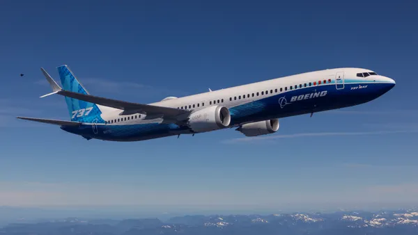 A blue and white Boeing 737 Max 10 plane in flight.
