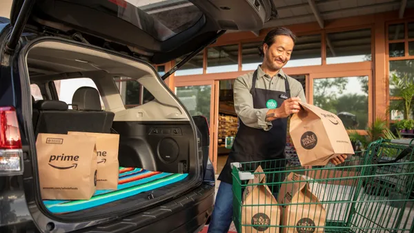 Person moving a paper grocery bag