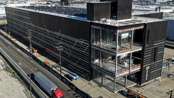 A large, three-story building under construction