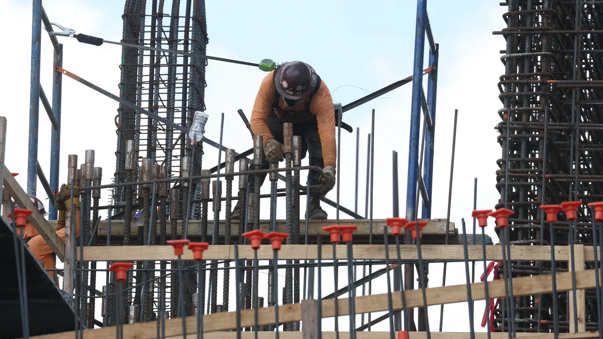 Construction workers help build a condo tower using steel rebar on Feb. 10, 2025, in Miami, Fla.