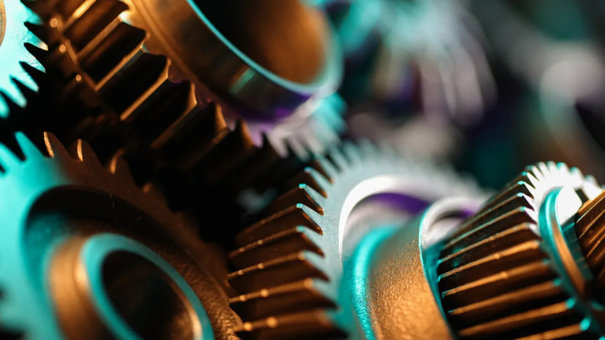 Close-up of interlocking industrial gears, symbolizing precision and efficiency in manufacturing.