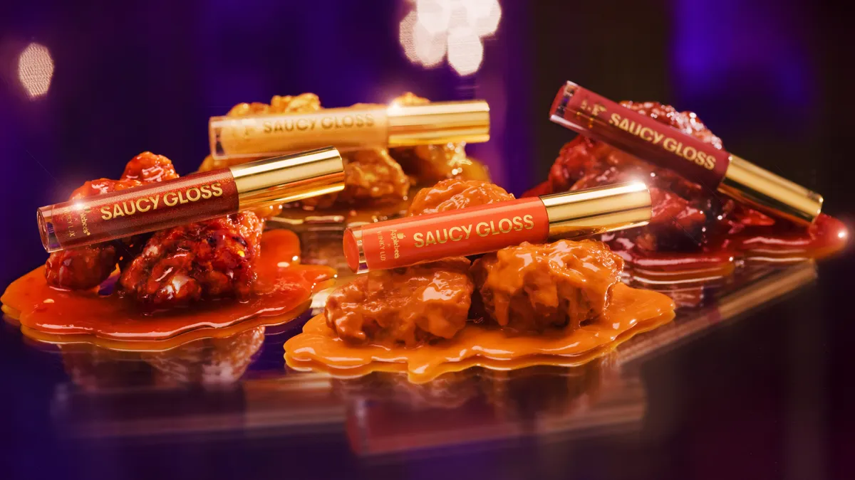 Four lip glosses that correspond to matching Applebee's chicken wing flavors