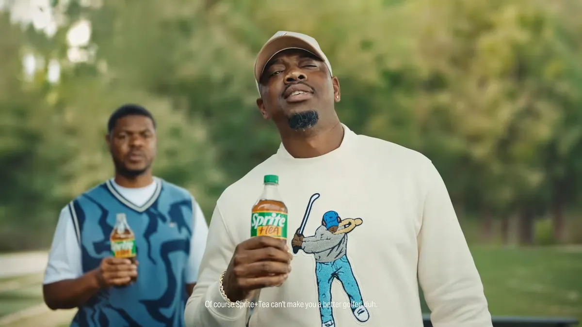 Two people hold Sprite + Tea on a golf course in an ad