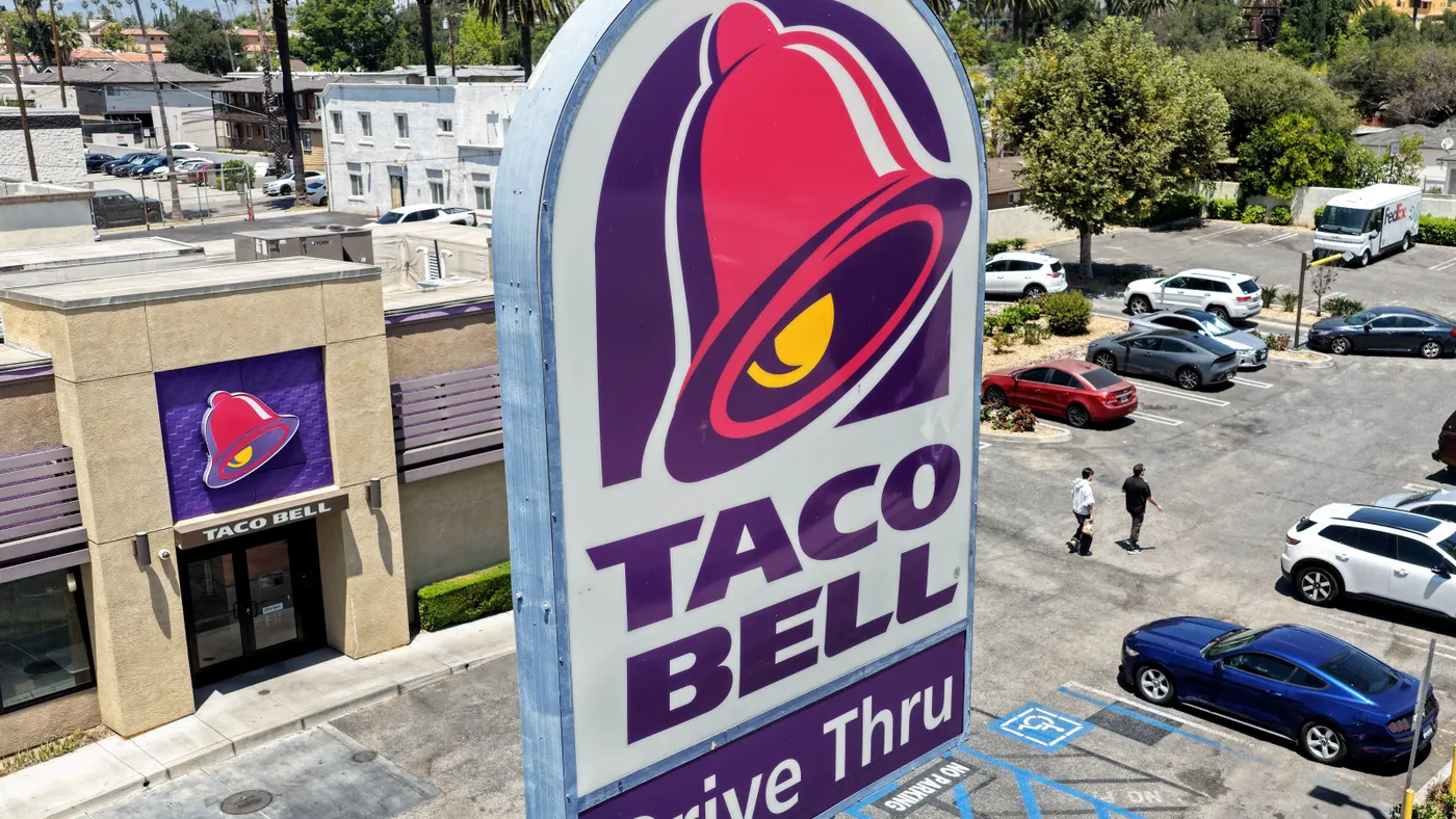 An aerial photograph of a Taco Bell sign next to a Taco Bell restaurant.