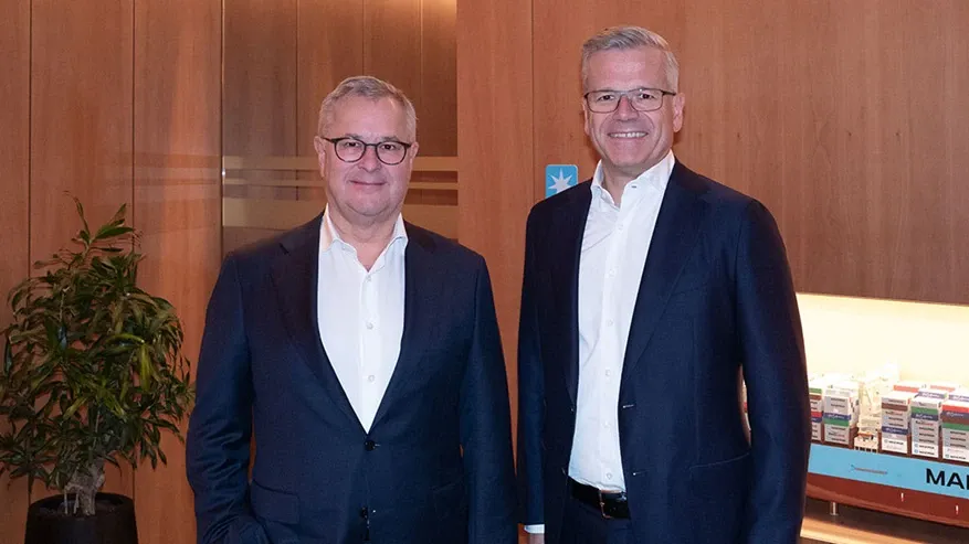 Retiring CEO Soren Skou stands next to his replacement, Vincent Clerc.