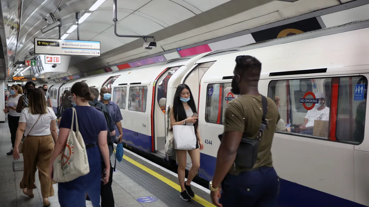 Commuters and shoppers opt to continue wearing face coverings on the London Underground system despite it no longer being enforced.