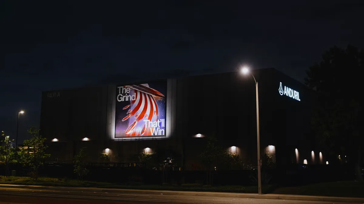 A building appearing dark at night, with street lights facing outward and surrounding it.