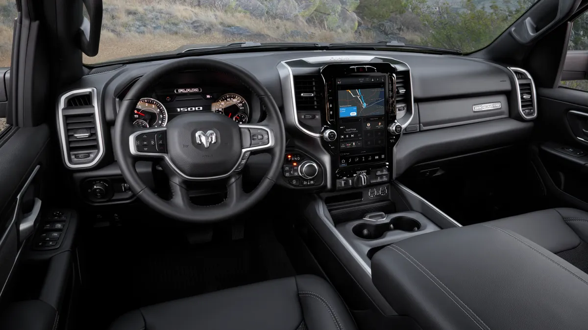 The black colored interior of a 2002 Ram 1500 pickup showing the dashboard view from the rear seat.