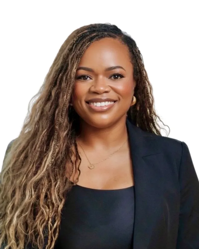 Headshot of a smiling woman in business attire.