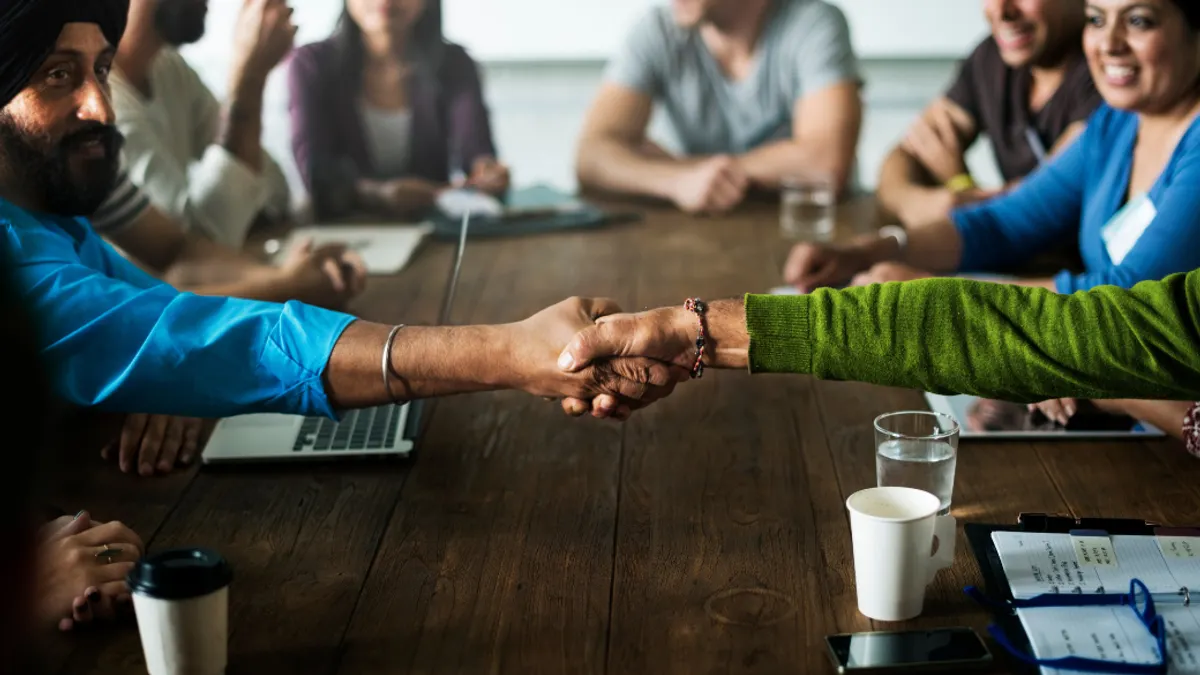 People shaking hands in a meeting