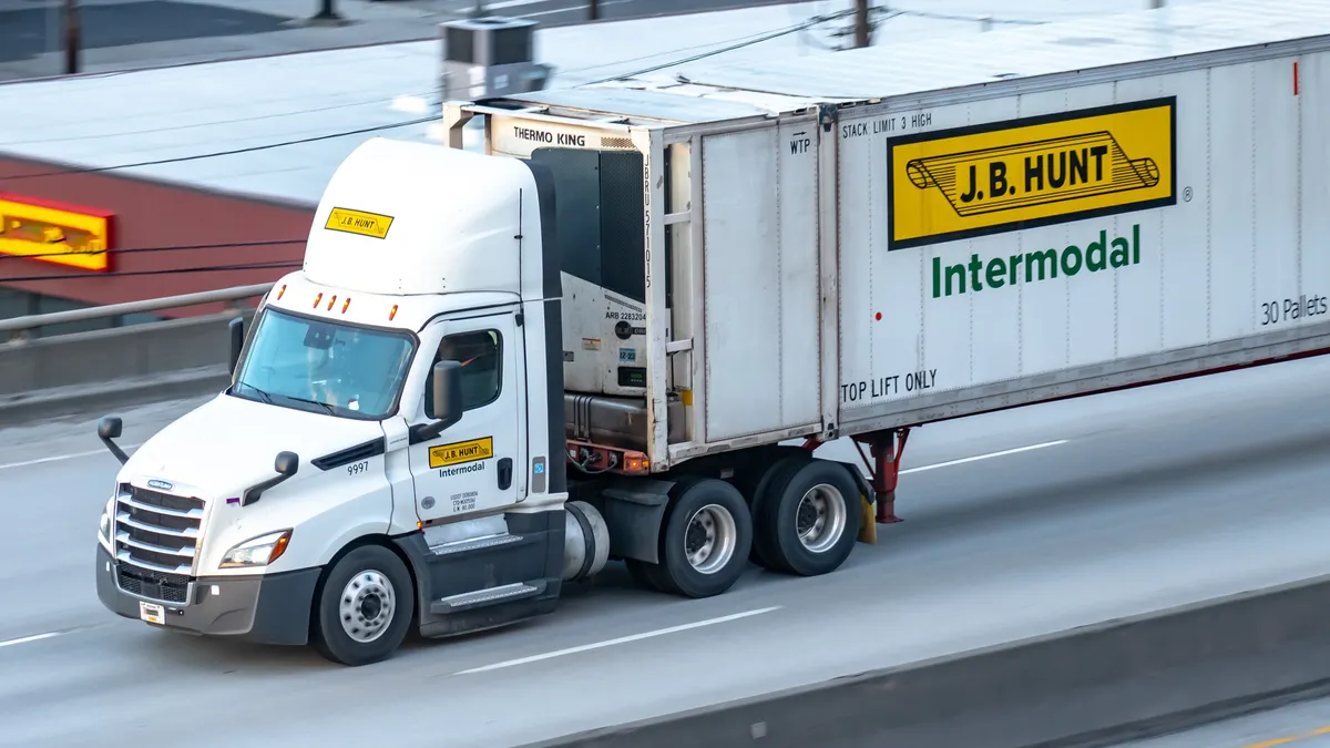 A semi-truck driving on a freeway.
