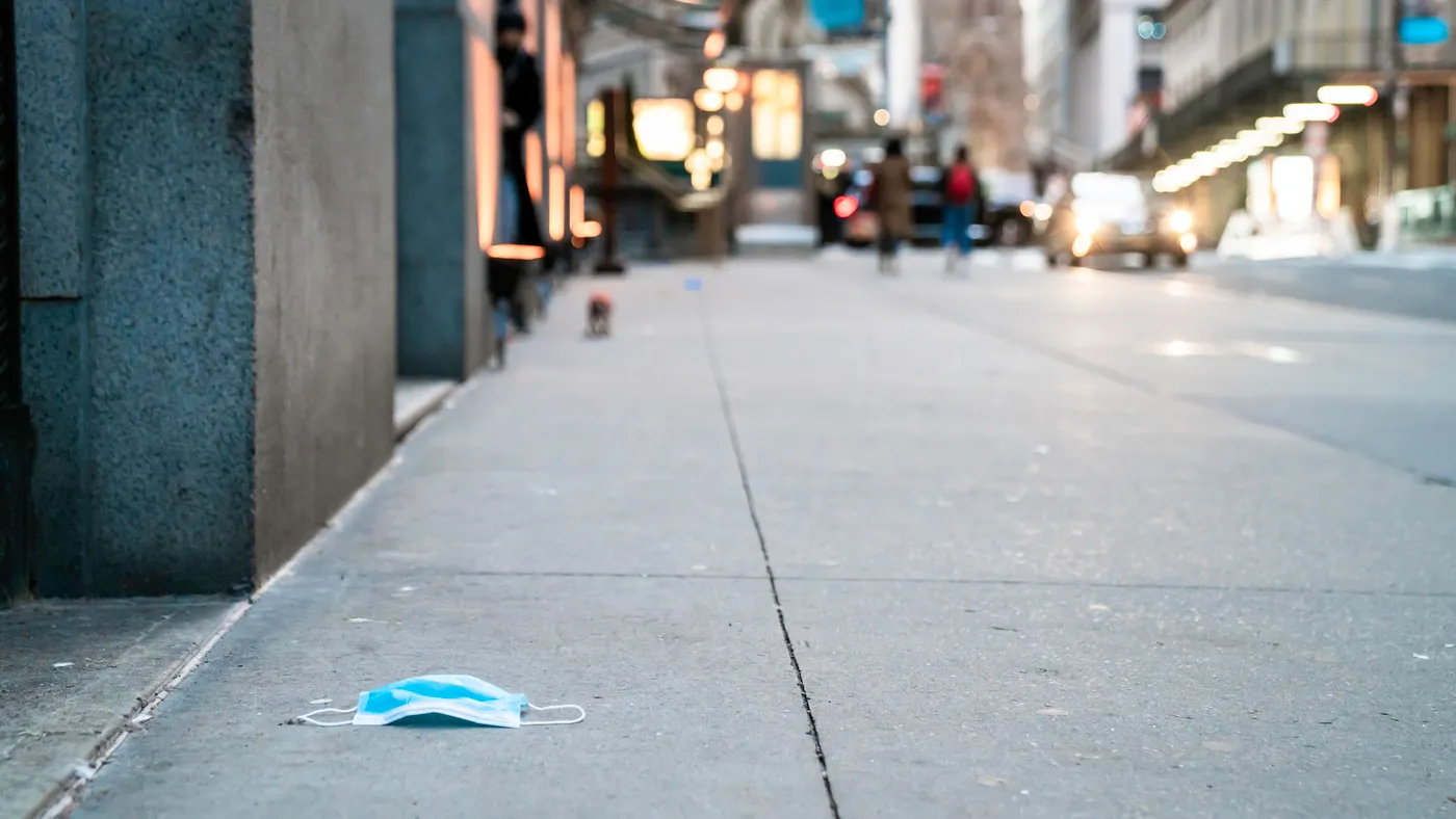 Mask discarded on sidewalk
