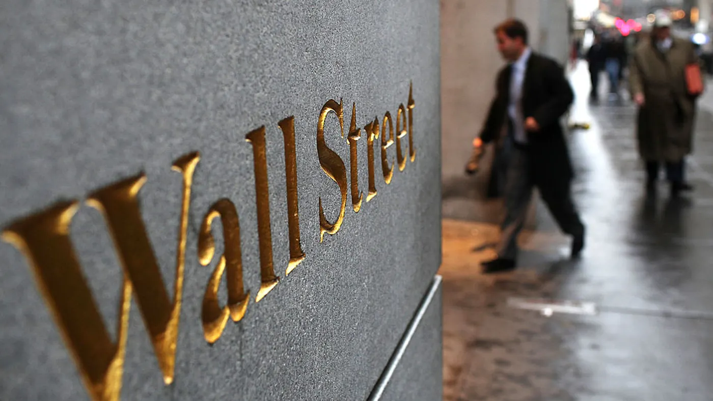 Engraving on a wall reads "wall street."
