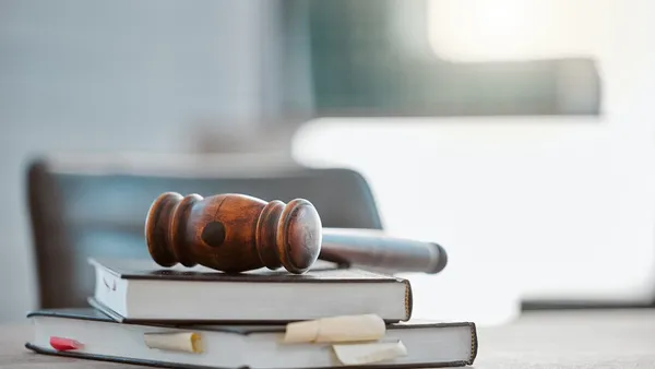 Justice, gavel and law books on table in office.