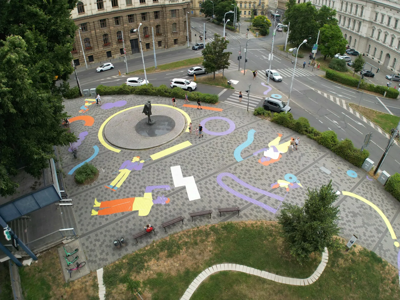 Aerial shot of plaza painted with shapes and cartoon people