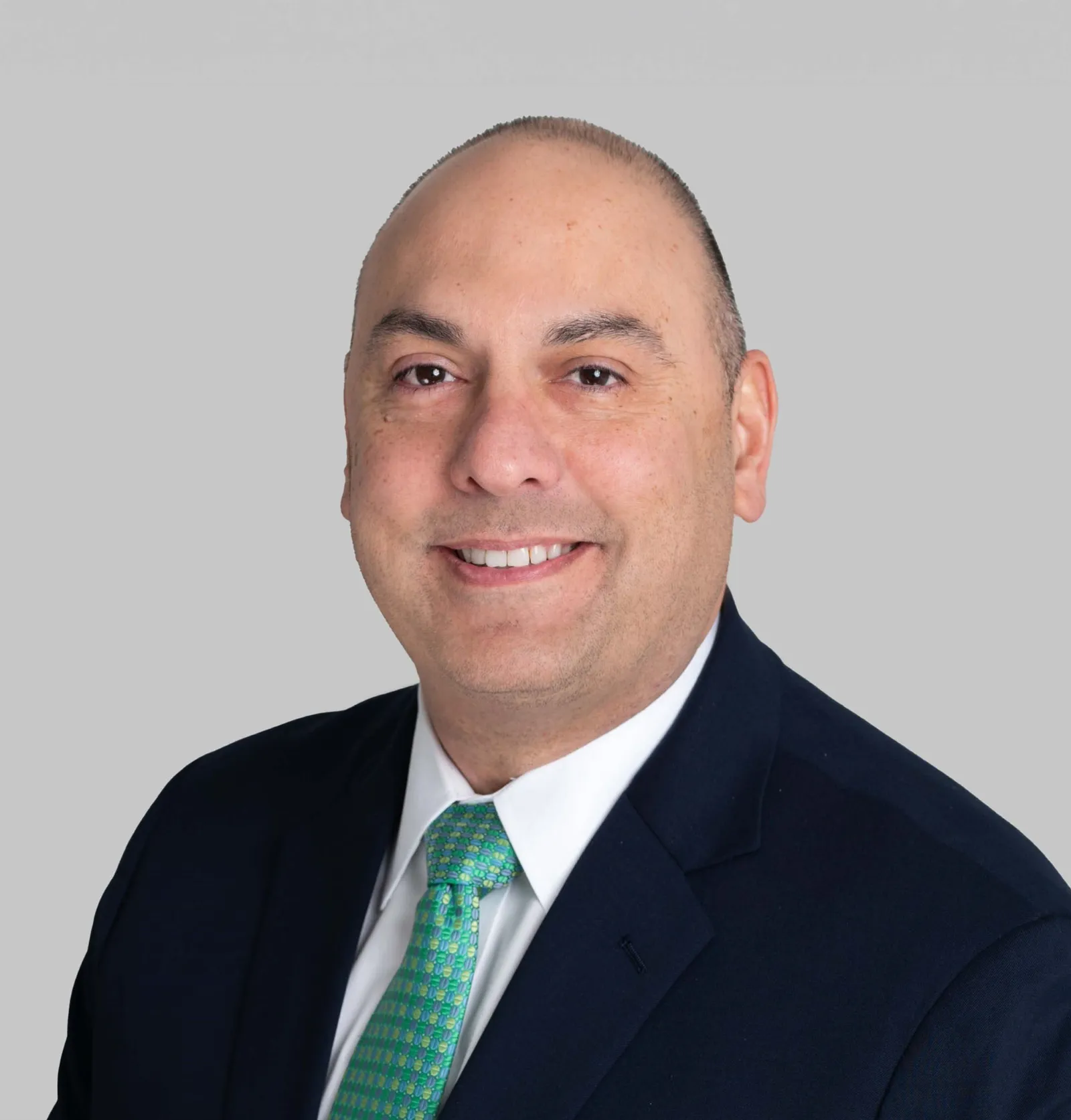 A head shot of a person wearing a suit and tie.