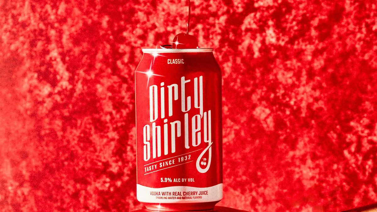 A can of Dirty Shirley is balanced on a person.