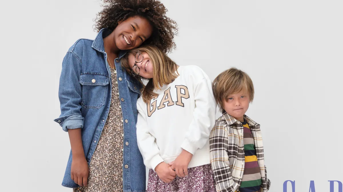 Three children pose together in GapKid's Fall 2022 back-to-school campaign.