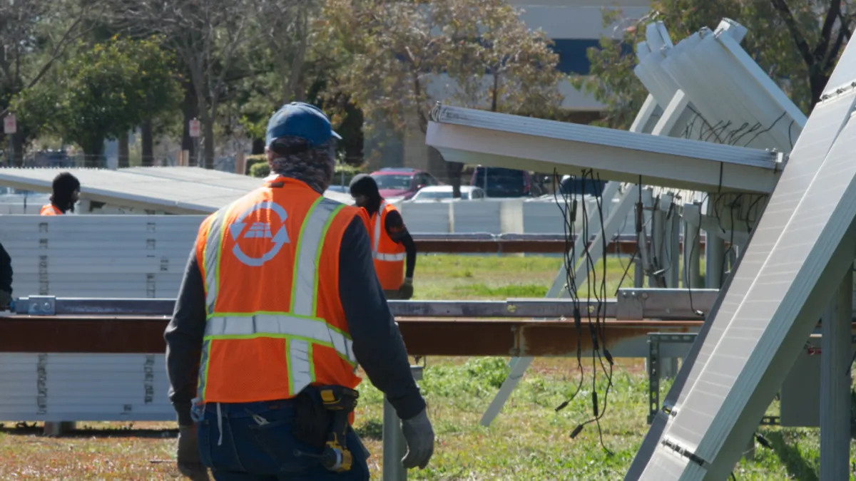 Team of engineers and technicians working together on a solar panel