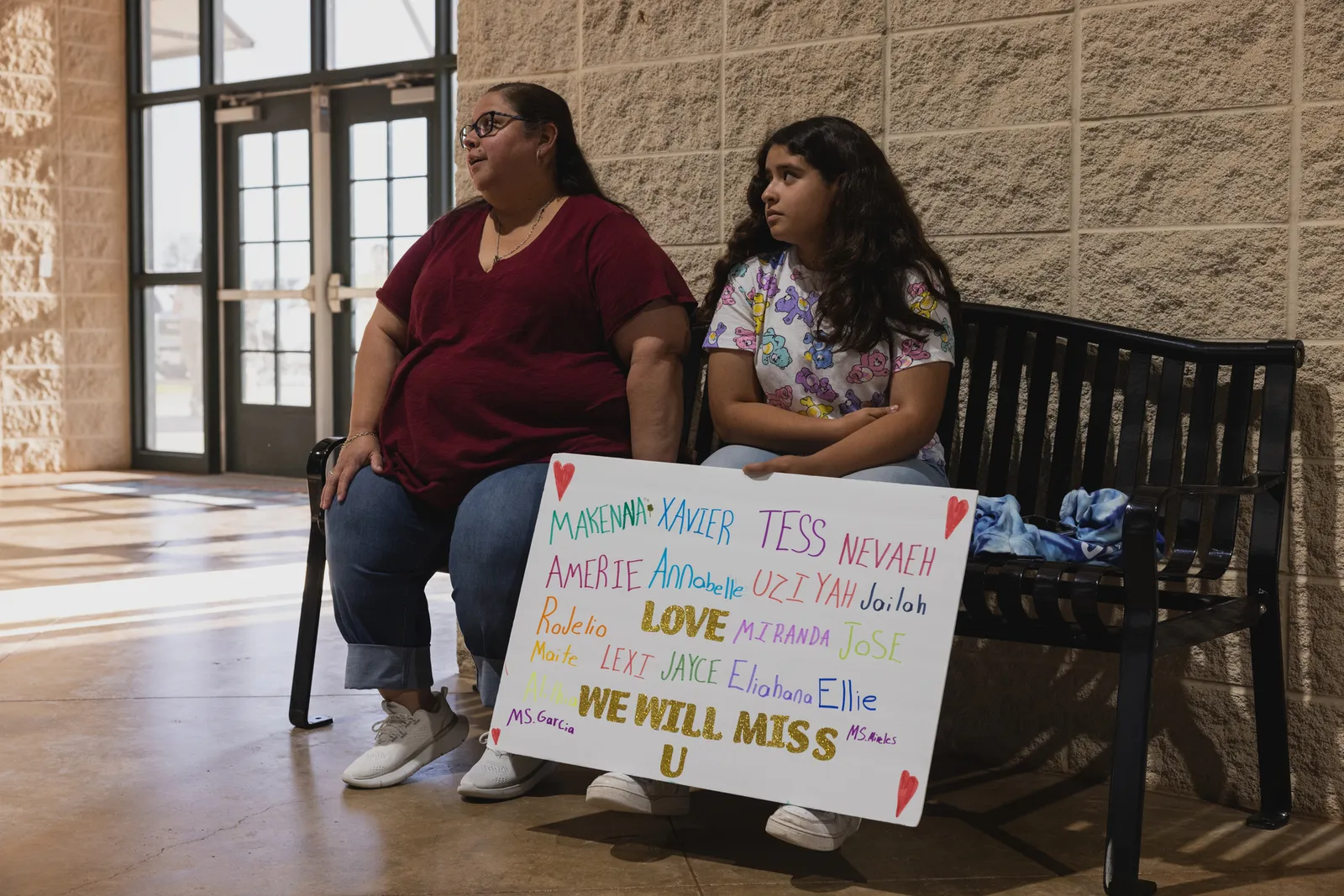 A young girl who did not wish to be named holds a sign bearing the names of the victims at a vigil for 21 people killed at Robb Elementary School on May 24, 2022 in Uvalde, Texas.