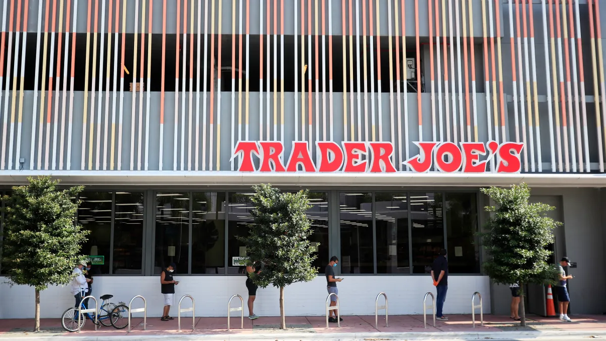 People in line outside a Trader Joe's store.