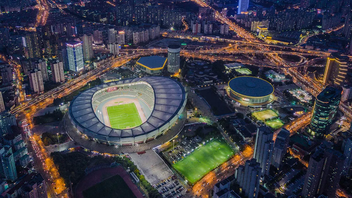 Lit up sky view of city and sports stadium