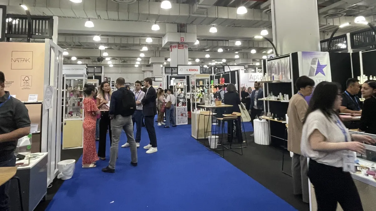 People standing in a convention center at Luxe Pack 2024