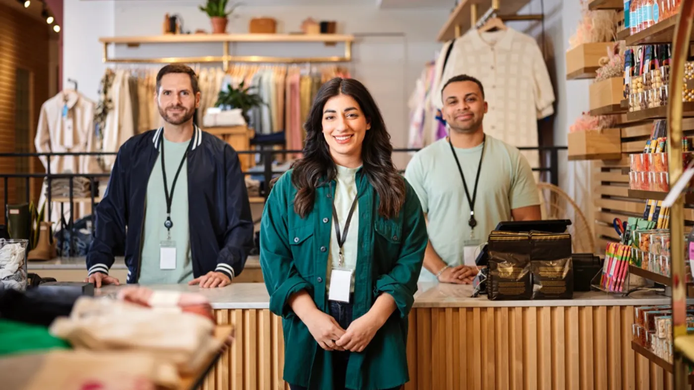 Retail workers posing for photo in their shop