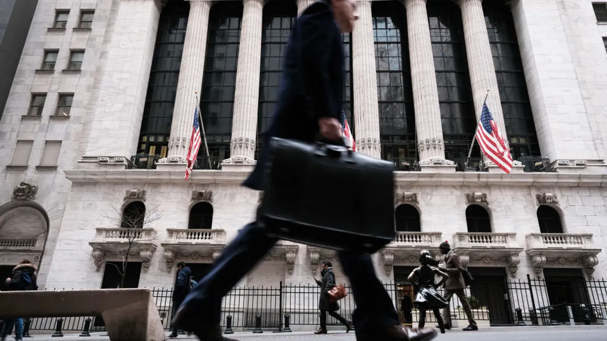 People walk past the New York Stock Exchange
