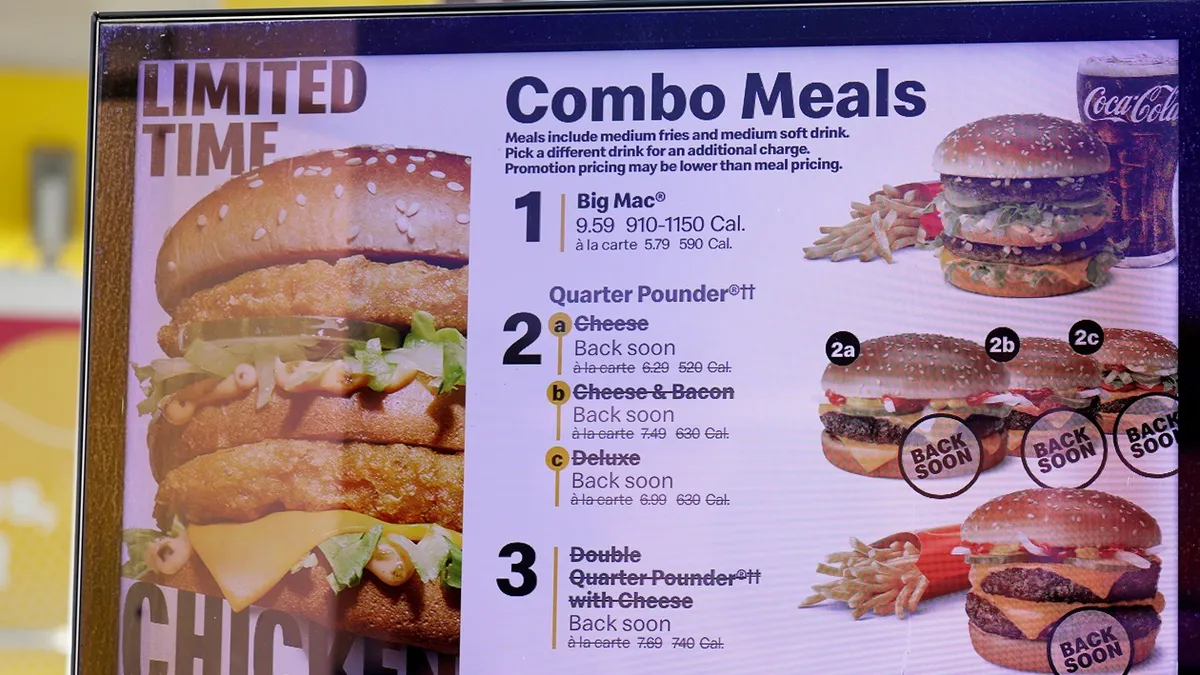 An image of a McDonald's sign with Combo Meals. The Quarter Pounder meals are crossed out and say they will be back soon.