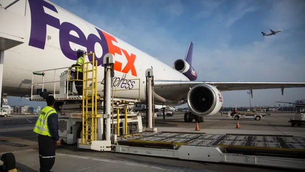 Workers prepare to offload an incoming FedEx plane at a FedEx global hub on December 16, 2014 in Newark, New Jersey.