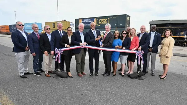 A governor and other individuals attend a ribbon-cutting ceremony.