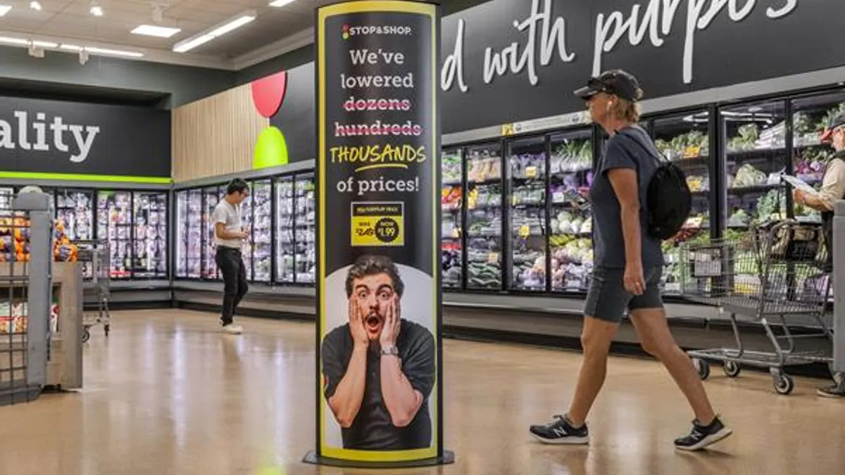 A sign about lower prices in a grocery store.