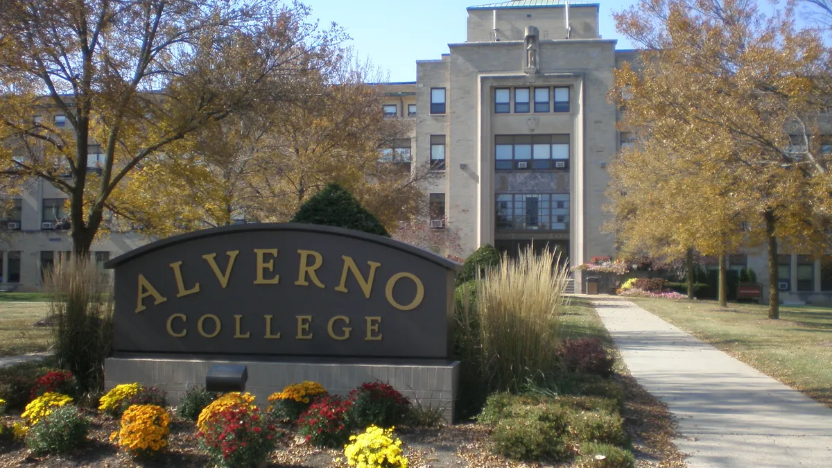 Alverno College sign in the foreground, a building behind it.