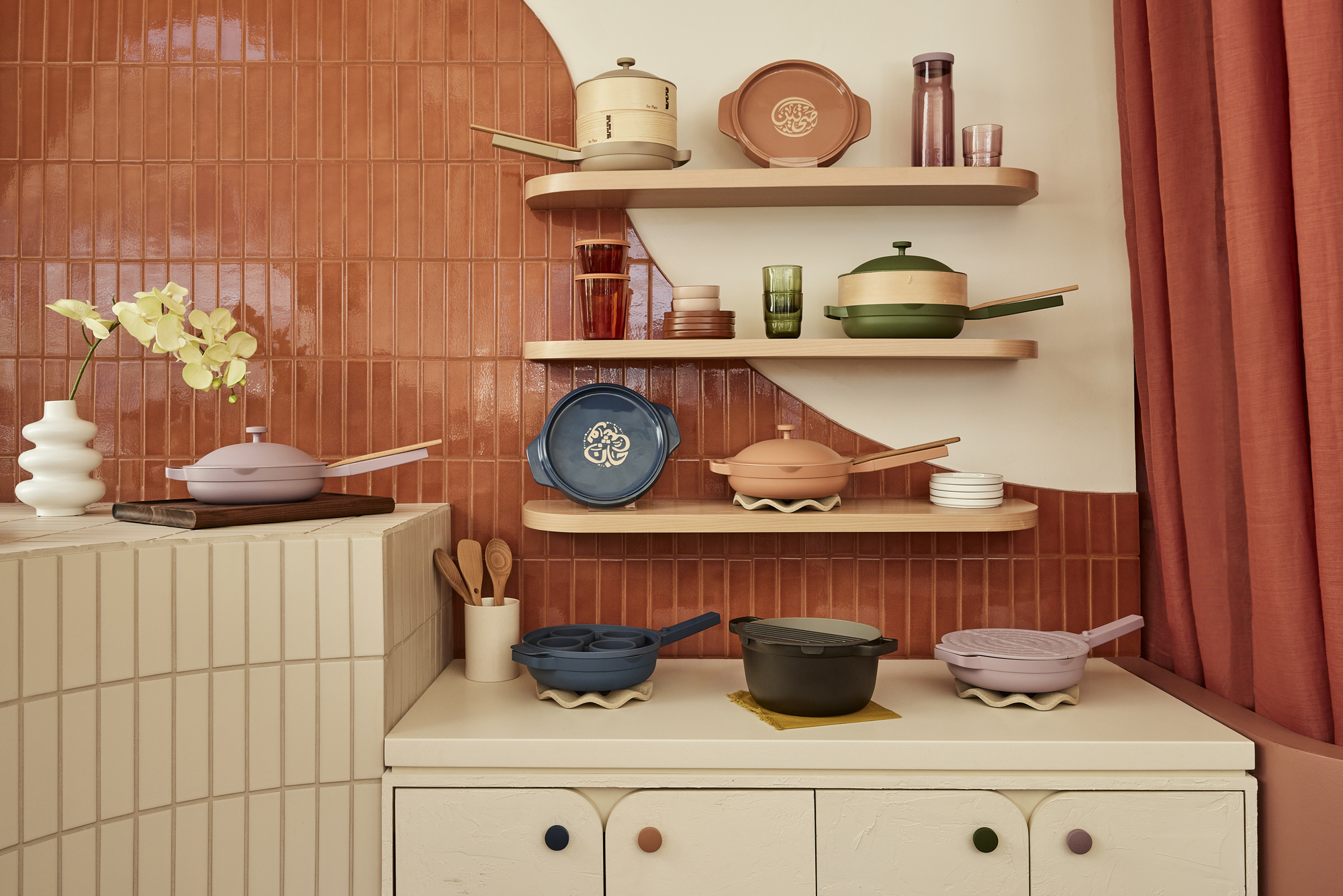 Our Place's pots and pans stacked on a shelf in the store