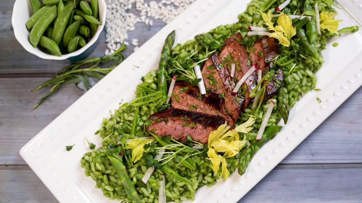 A dish featuring a steak analog made by Meati