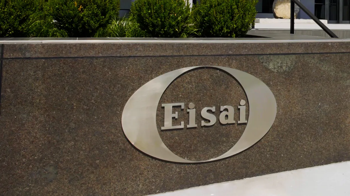 A sign showing the Eisai logo outside of a building
