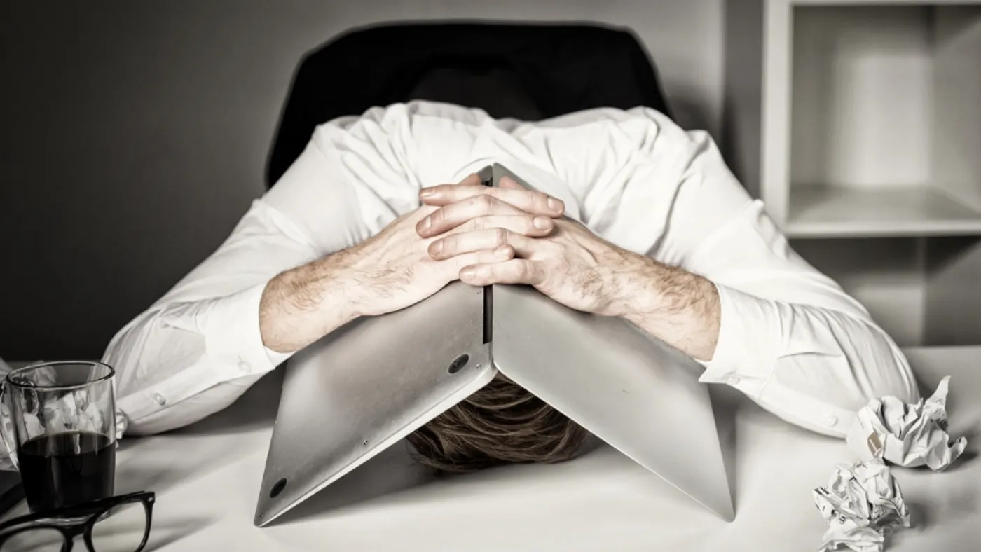 person with head on the desk